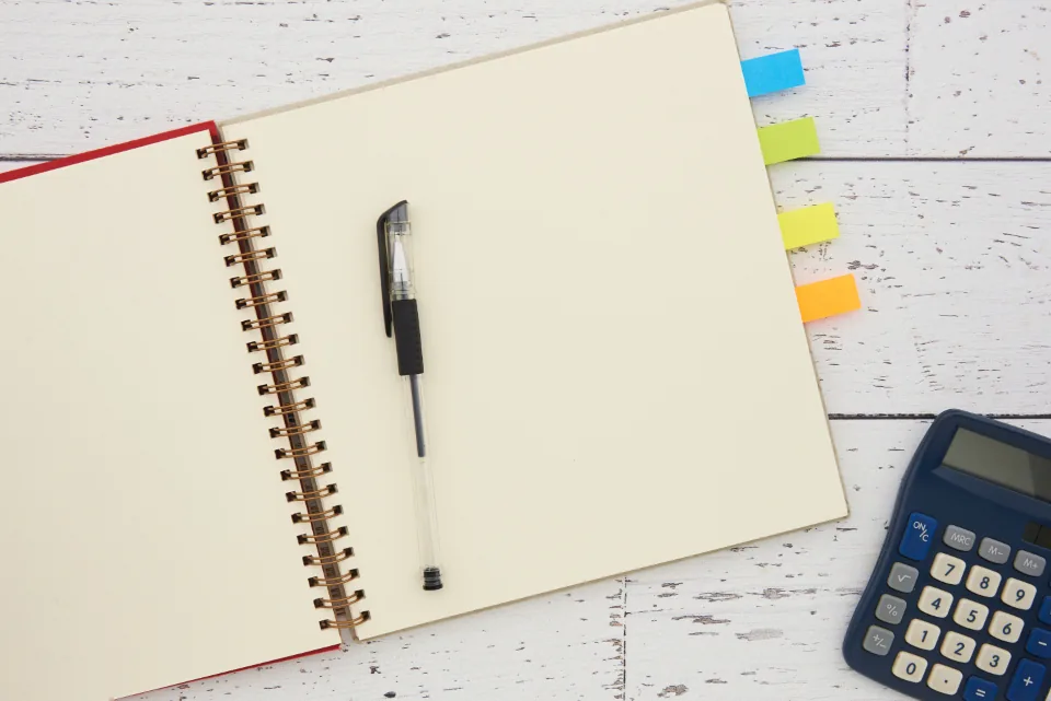 Tax documents and a calculator on a desk (stock photo).